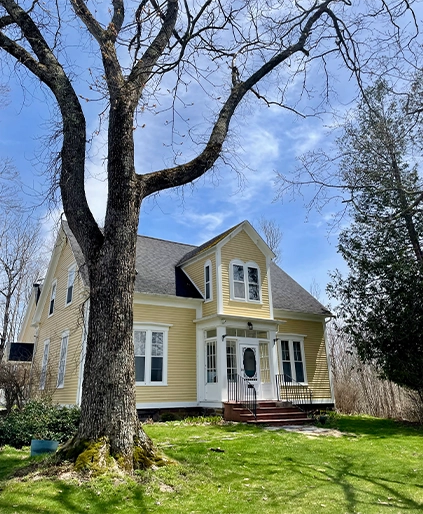 The yellow Victorian house of Balsam Parlour on a sunny day